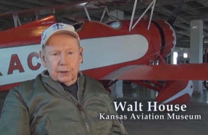 Kansas aviation historian Walt House speaking in the 2015 film 'Indians in Aviation' at the Kansas Aviation Museum, in front of a 1930s Stearman 4D biplane he helped to restore.